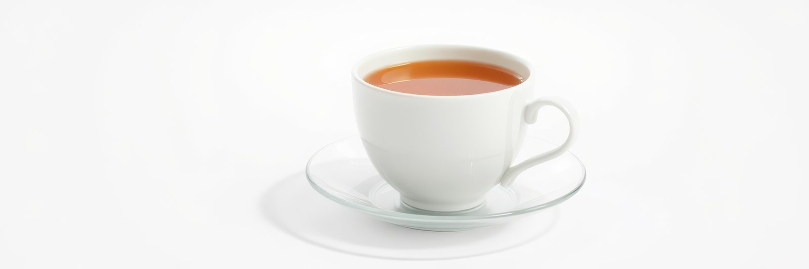 Warm cup of tea served on a white saucer with a simple background for a calming experience